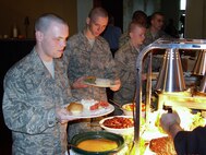 Air Force Trainee Timothy Reuwer from Deltona, Fla., piles his plate with turkey and all the trimmings at the Cypress Grille. The restaurant, located in Boerne, Texas, fed 100 Week 1 trainees on Thanksgiving day. (USAF photo by Tony Perez)