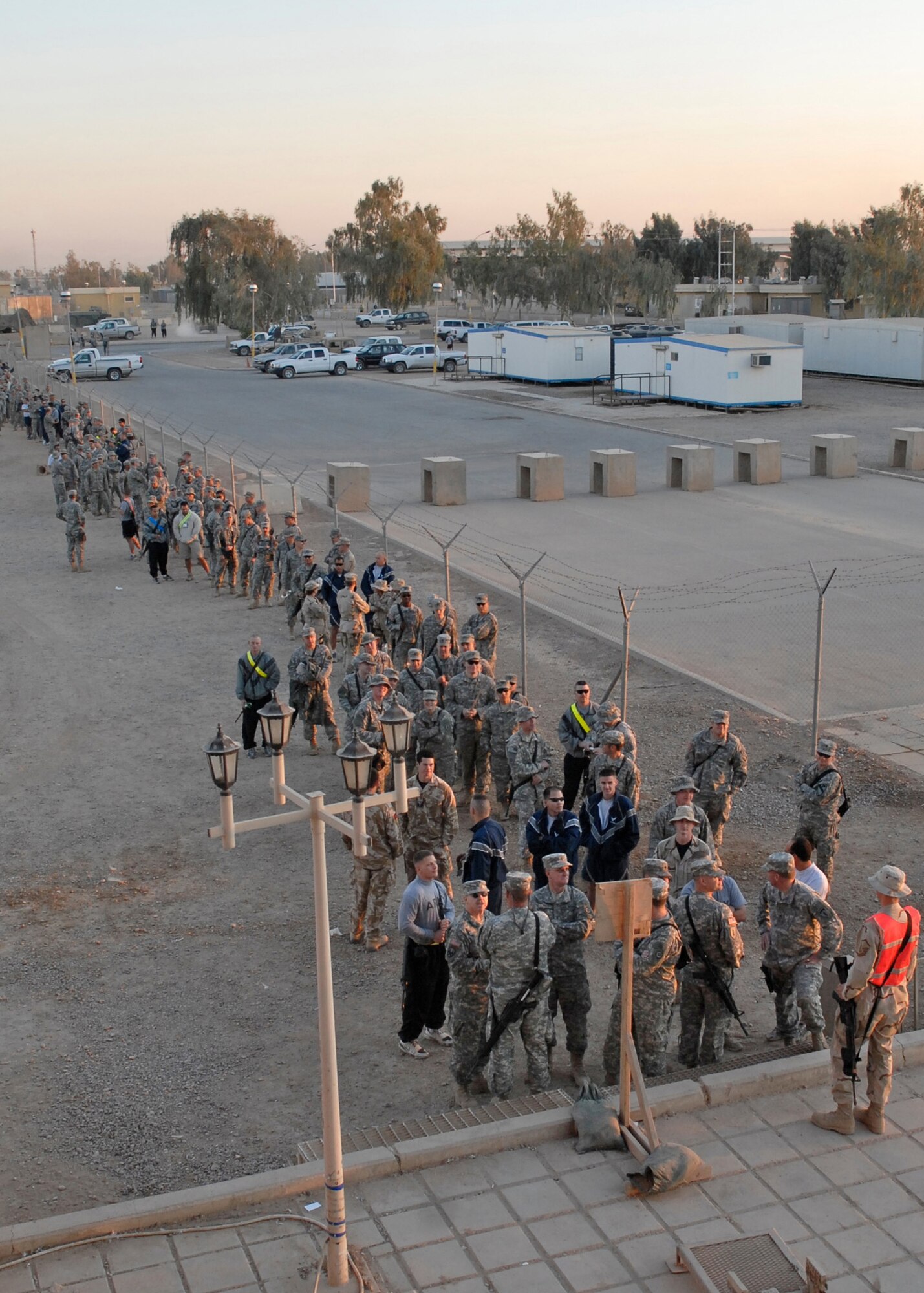 U.S. and coalition servicemembers line up to see the Operations Season's Greetings 2007 show at Balad Air Base, Iraq, Nov. 23. Country singer Jamie O'Neal, Latin sensation Melina Leon, the New England Patriots Cheerleaders, comedian Dick Hardwick and members of the U.S. Air Forces in Europe and Band of the Air Force Reserve performed for a standing room only crowd at the base  theater.  (U.S. Air Force photo/Ken Hackman)