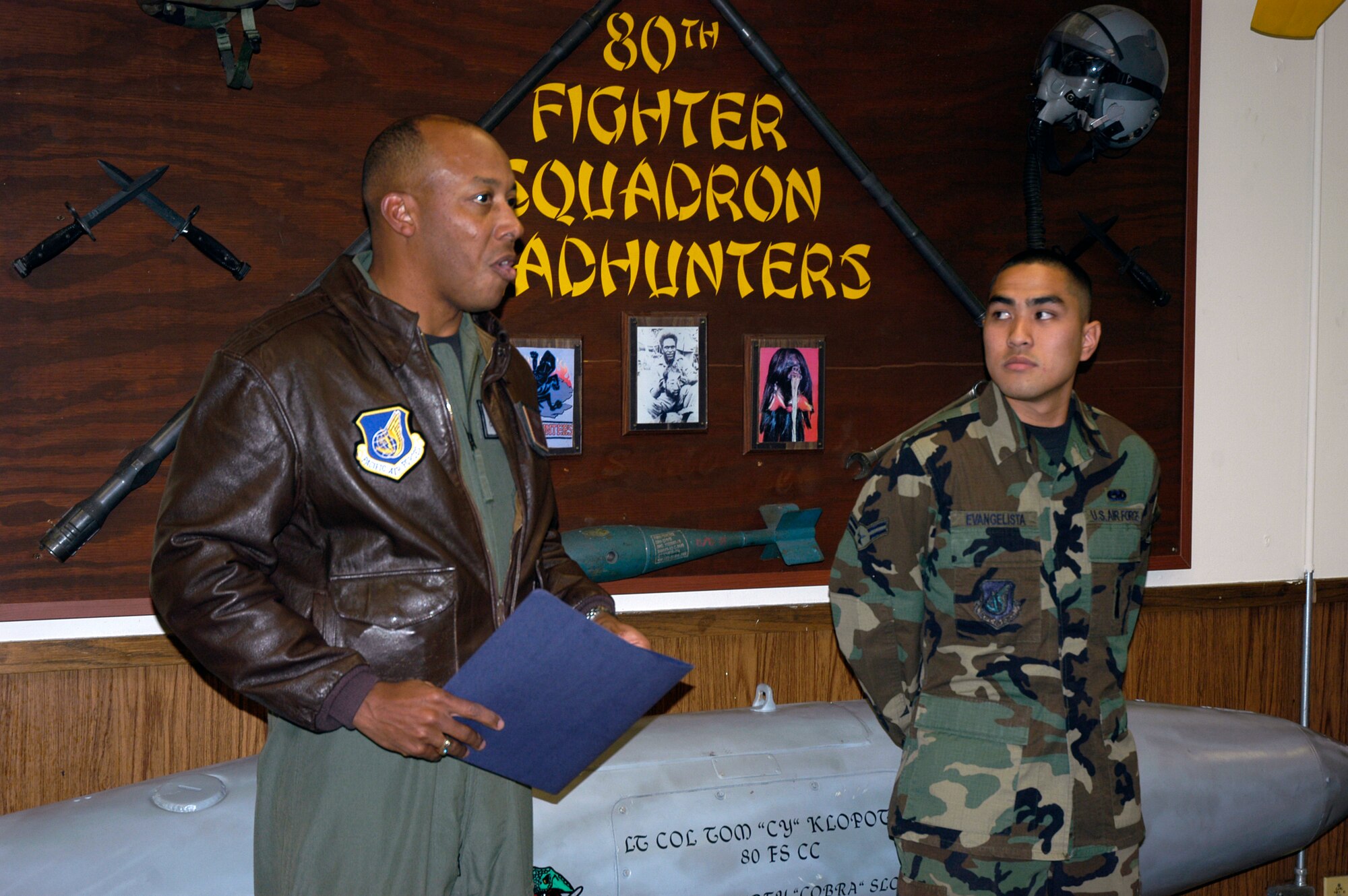 KUNSAN AIR BASE, South Korea --  Colonel CQ "Wolf" Brown, 8th Fighter Wing commander, congratulates Airman 1st Class Antonio Evangelista, 8th Aircraft  Maintenance Squadron aircraft armament weapons specialist, here Nov. 19. Airman Evangelista was recognized as the wing's Pride of the Pack for the week of Nov. 19. (U.S. Air Force photo/Staff Sgt Alice Moore) 