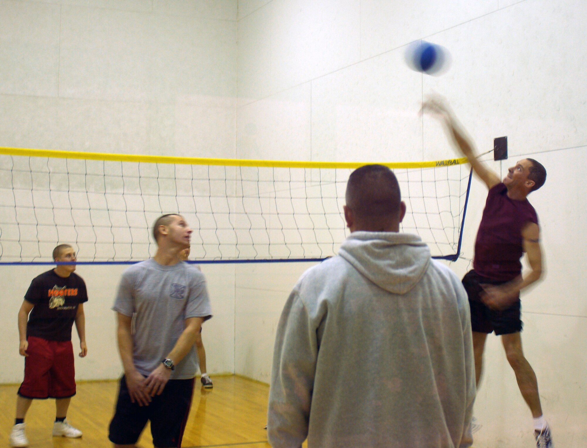 Senior Master Sgt. Joe Davis, 71st Mission Support Squadron, hits the ball to his Airmen opponents during the Dorm Wars volleyball game that pitted Airmen against NCOs Nov. 23 at the base fitness center. More than 25 Team Vance members participated in the camaraderie building events. (U.S. Air Force photo by Master Sgt. Joe Lawley)