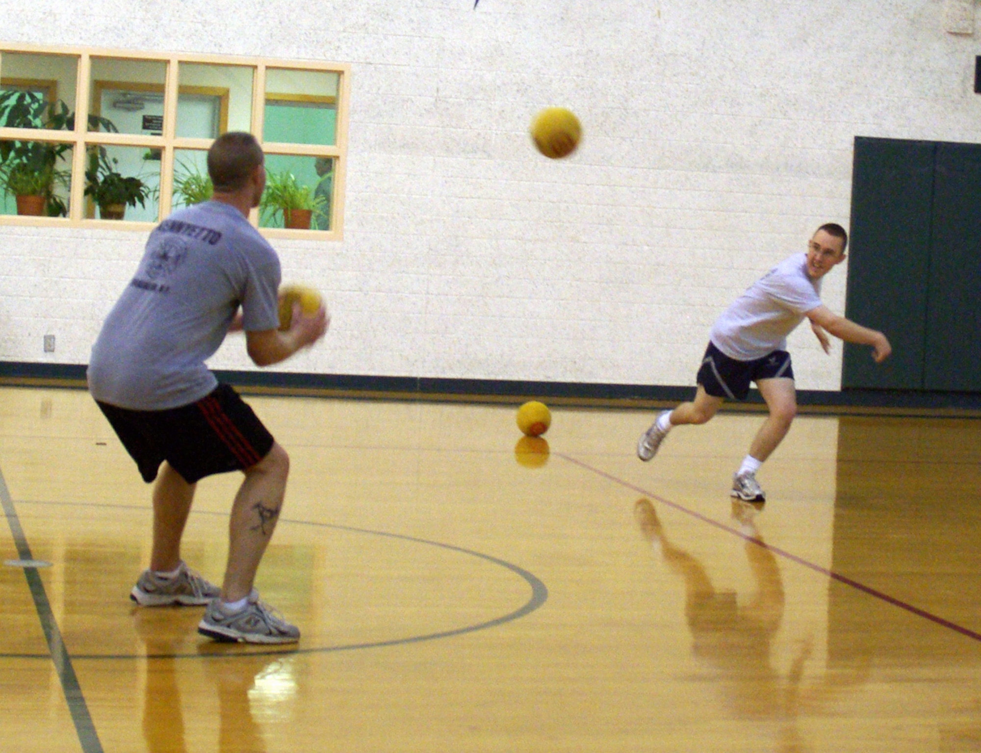 Airman 1st Class Joshua Lewis, 71st Medical Group, whips a dodge ball at Tech. Sgt. Todd Rosenzweig, 71st Security Forces Squadron, during a Dorm Wars walleyball competition Nov. 23 at the base fitness center.  More than 25 Team Vance members participated in the Airmen vs. NCO events to build camaraderie and boost morale. (U.S. Air Force photo by Master Sgt. Joe Lawley)
