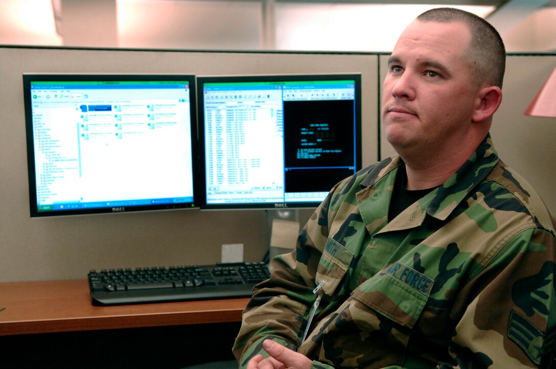 U.S. Air Force Senior Airman Robert Smith, from the Air Force Financial Service Center (AFFSC), talks with a co-worker while reviewing financial documents at Ellsworth Air Force Base, S.D., Nov. 21, 2007.  Smith processes pay and entitlements in the Air Combat Command Military Pay section of the AFFSC.  (U.S. Air Force photo by Staff Sgt. Michael B. Keller)(Released)