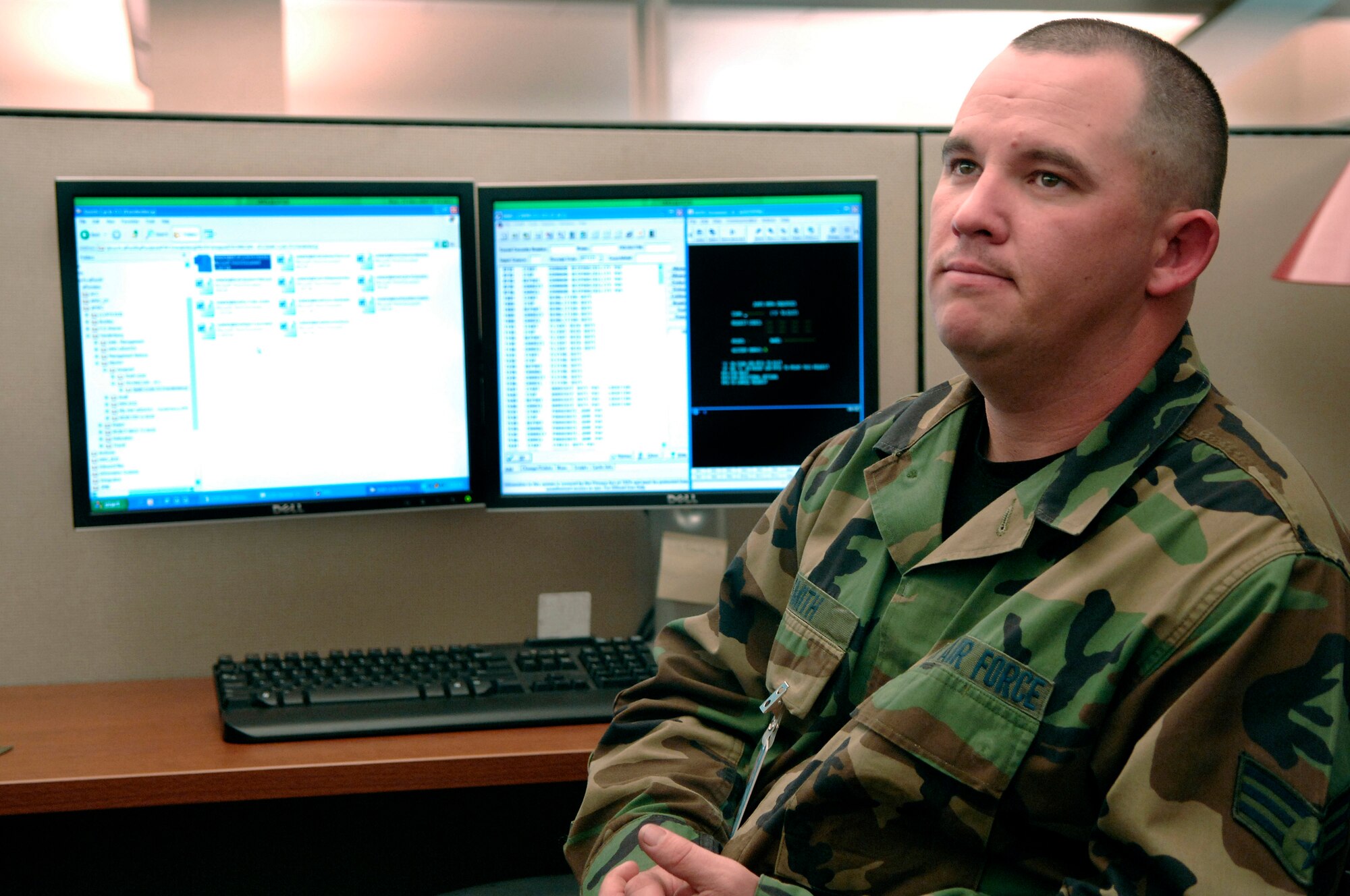 U.S. Air Force Senior Airman Robert Smith, from the Air Force Financial Service Center (AFFSC), talks with a co-worker while reviewing financial documents at Ellsworth Air Force Base, S.D., Nov. 21, 2007.  Smith processes pay and entitlements in the Air Combat Command Military Pay section of the AFFSC.  (U.S. Air Force photo by Staff Sgt. Michael B. Keller)(Released)