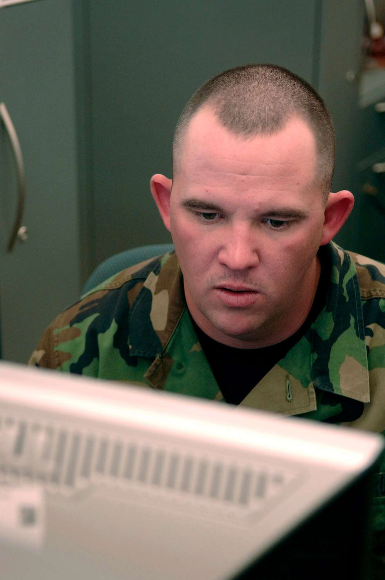 U.S. Air Force Senior Airman Robert Smith, from the Air Force Financial Service Center (AFFSC), reviews financial documents at Ellsworth Air Force Base, S.D., Nov. 21, 2007.  Smith processes pay and entitlements in the Air Combat Command Military Pay section of the AFFSC.  (U.S. Air Force photo by Staff Sgt. Michael B. Keller)(Released)