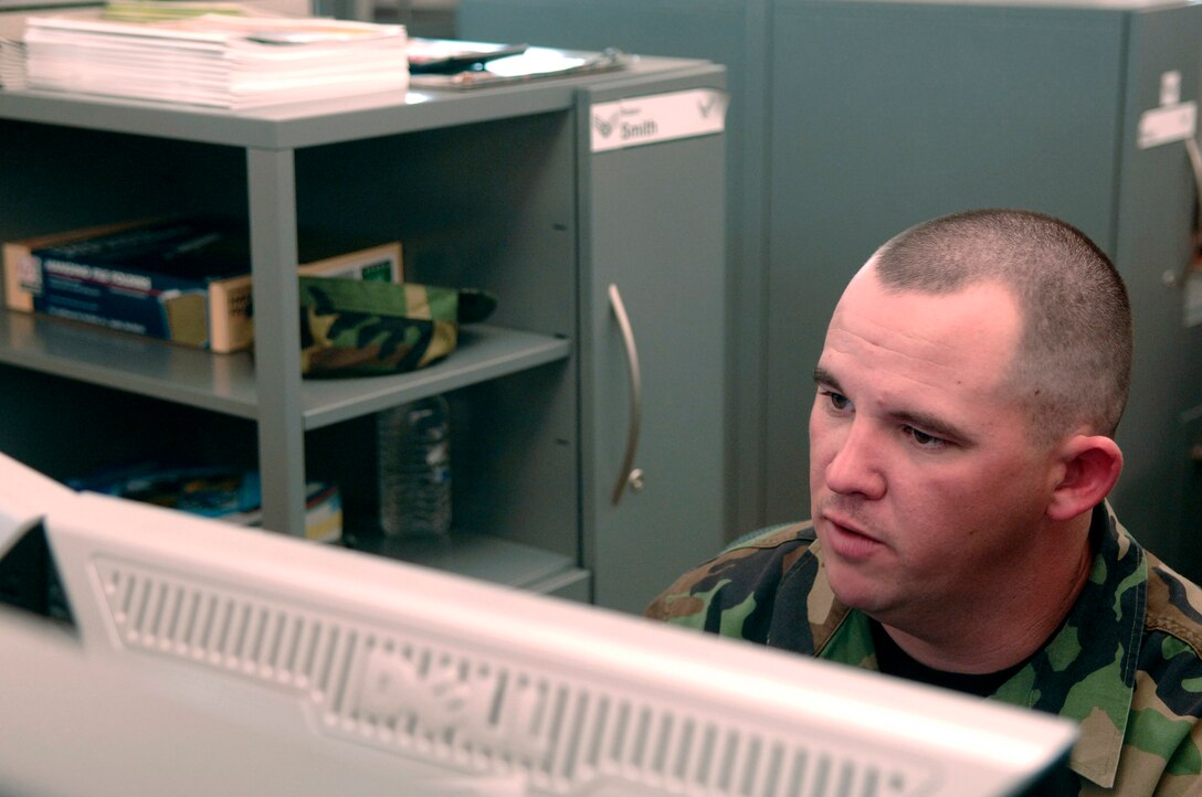 U.S. Air Force Senior Airman Robert Smith, from the Air Force Financial Service Center (AFFSC), reviews financial documents at Ellsworth Air Force Base, S.D., Nov. 21, 2007.  Smith processes pay and entitlements in the Air Combat Command Military Pay section of the AFFSC.  (U.S. Air Force photo by Staff Sgt. Michael B. Keller)(Released)