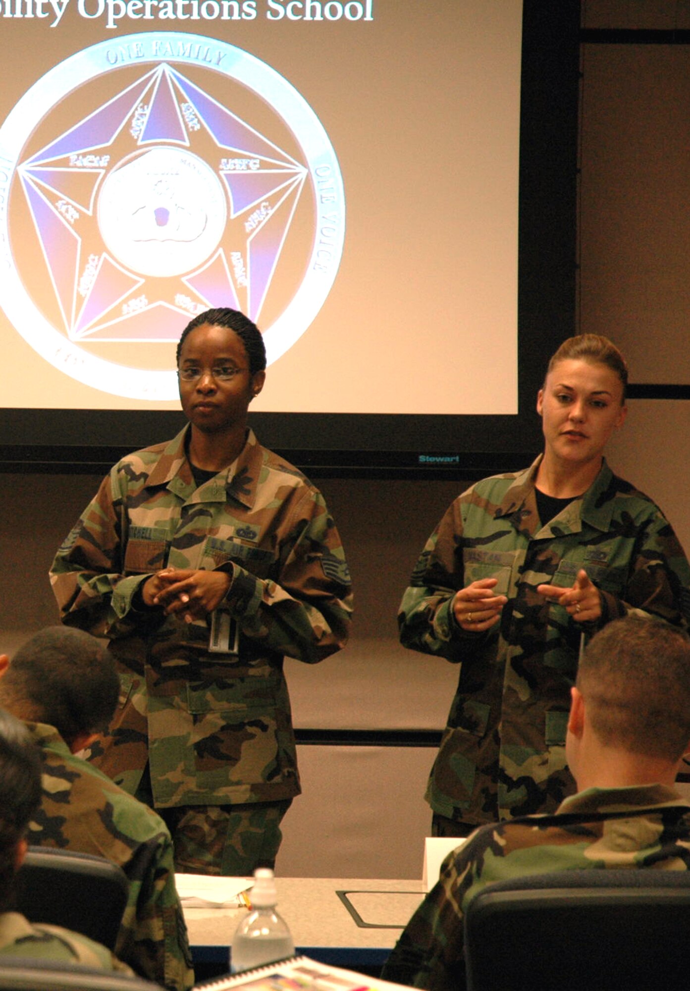 Staff Sgt. Khadejah Mitchell and Tech. Sgt. Jennifer Mastan, both aviation resource management instructors for the U.S. Air Force Expeditionary Center's Mobility Operations School, begin a new class Sept. 11 at the USAF EC on Fort Dix, N.J.  (U.S. Air Force Photo/Tech. Sgt. Scott T. Sturkol)
