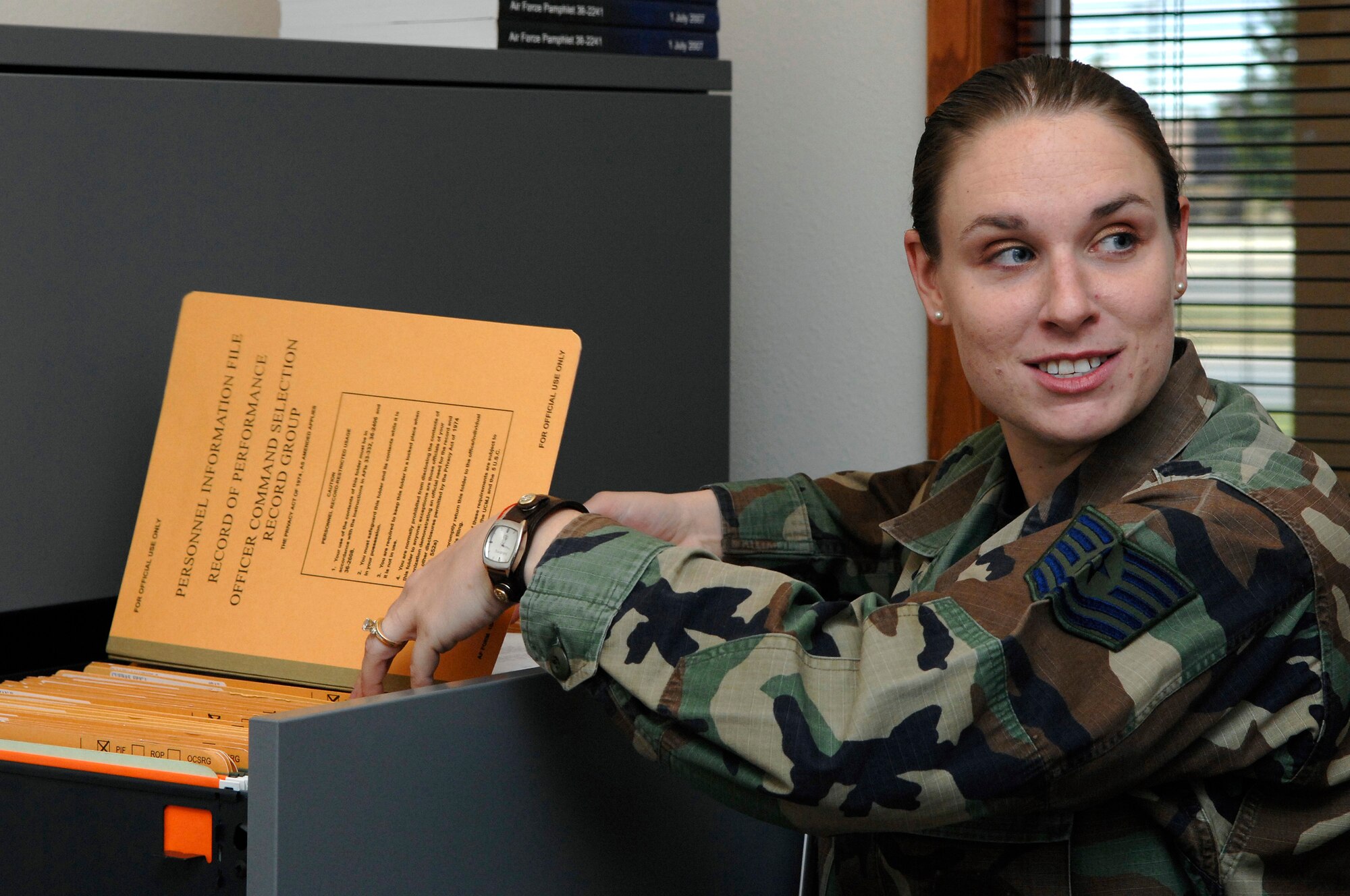 U.S. Air Force Tech. Sgt. Sharla Riley,from the Air Force Financial Service Center (AFFSC), files away personnel paperwork at Ellsworth Air Force Base, S.D., Nov. 21, 2007.  Riley deals with a multitude of issues daily as the Non-Commissioned Officer in Charge of the AFFSC Commander's Support Staff.  (U.S. Air Force photo by Staff Sgt. Michael B. Keller)(Released)