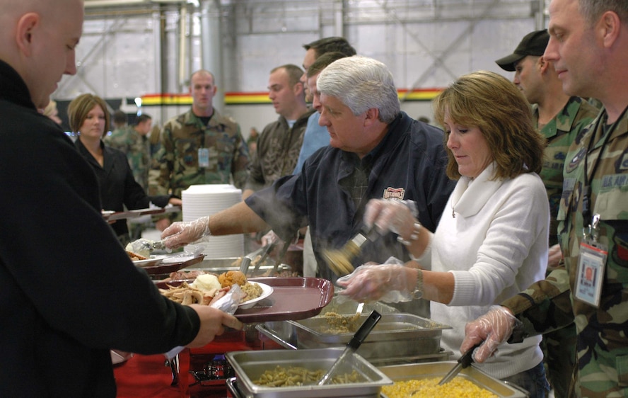 U.S. Congressman Rob Bishop (center), serves food to the 388th and 419th Fighter Wing servicemembers in Hangar 37 Nov. 21 for the wings' Thanksgiving feast.