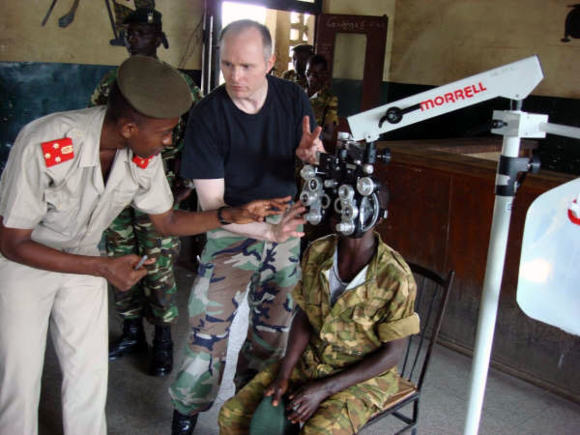 Maj. (Dr.) Craig McCluer and African military doctor, Dr. Pamphile Nkurunziza examine a patient at Gakumbu military base, Africa. Major McCluer is part of a team sent to provide eye care Nov. 6 to 15 to two Burundi, Africa, battalions preparing to deploy on a peacekeeping mission to Somalia. Major McCluer is an optometry specialist from the 52nd Aerospace Medicine Squadron at Spangdahlem Air Base, Germany, and  Dr. Nkurunziza is the Burundi Division surgeon. (Courtesy photo) 