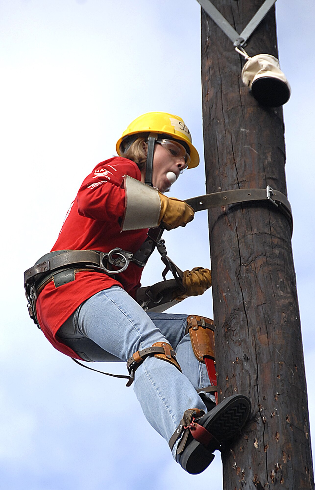Hundreds of Airmen and Sailors are trained each year at Sheppard in various skills used in the electrical systems career field. These trainees tested out their skills at the semi-annual Student Lineman's Rodeo Nov. 17 at the 366th Training Squadron's pole yard. Competitors, like Seaman Apprentice Stephanie Seale pictured here, were required to climb a pole, retrieve an egg from a pouch strapped at the top and climb down the pole with the egg in their mouth without it cracking or breaking. (U.S. Air Force photo/Harry Tonemah)