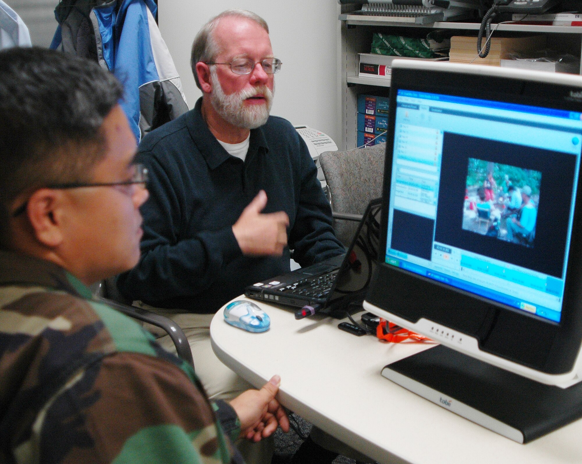 Rob Daves, The Everett Group, director of national studies, conducts an eye-tracking test with Capt. Brian Grocki, 2nd Space Warning Squadron, to see which parts of a photo draw his attention. The Everett Group was contracted to determine how people who access www.af.mil and the Air Force Portal navigate the sites and what changes could be made to make the sites more user friendly. (Photo by Staff Sgt. Scott McNabb)
