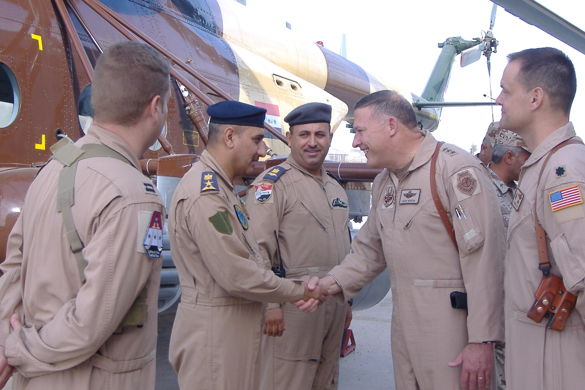 Camp Taji, Iraq -- Lt. Gen. Gary North, U.S. Central Command Air Forces and Combined Forces Air Component Commander greets Iraqi pilot trainees at Camp Taji. 