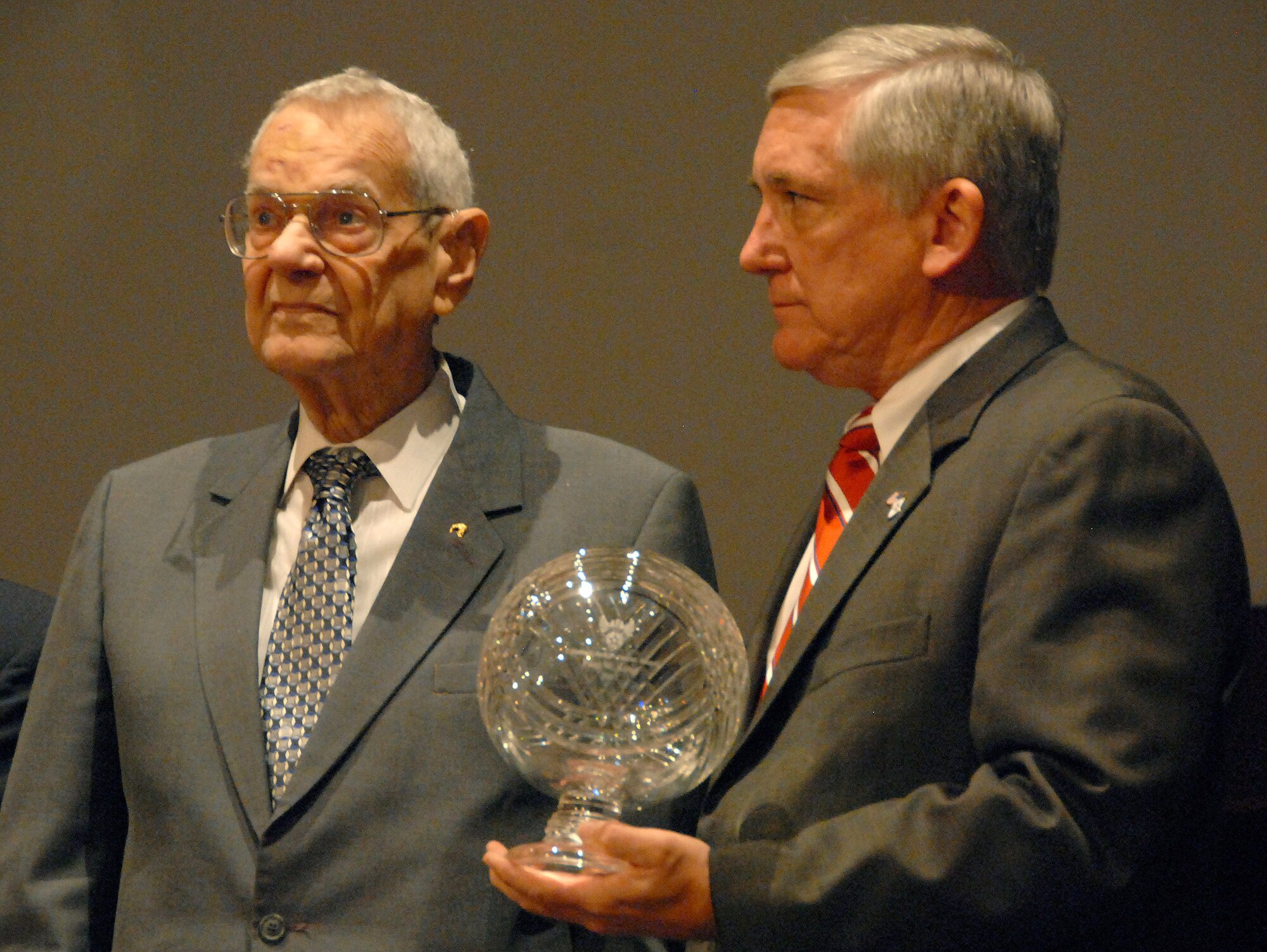 Retired Chief Master Sgt. of the Air Force Paul Wesley Airey receives the Air Force Association's Lifetime Achievement award from AFA's Chairman of the Board Robert Largent during a Nov. 20 ceremony at Maxwell-Gunter's Senior NCO Academy in Alabama. Chief Airey was the first chief master sergeant of the Air Force, and is the first enlisted member to receive the AFA award. (U.S. Air Force photo/Master Sgt. Scott Moorman)