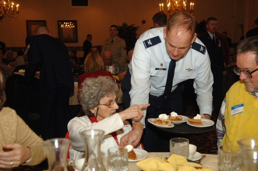 MINOT AIR FORCE BASE -- Col. Joel Westa, 5th Bomb Wing commander, lends a hand to a group of Minot senior citizens, serving up a free Thanksgiving meal during Minot Air Force Base's annual "Day of Love" celebration. The base has hosted the Day of Love since 1969, and its popularity with the base and local community has made it a long-standing tradition ever since. (U.S. Air Force photo by Airman 1st Class Sharida Bishop)