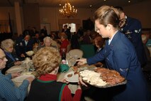 MINOT AIR FORCE BASE -- Airman 1st Class Megan Dunlevy, 91st Missile Maintenance Squadron, serves up a free Thanksgiving meal to a group of Minot senior citizens during Minot Air Force Base's annual "Day of Love" celebration. The base has hosted the Day of Love since 1969, and its popularity with the base and local community has made it a long-standing tradition ever since. (U.S. Air Force photo by Airman 1st Class Sharida Bishop)