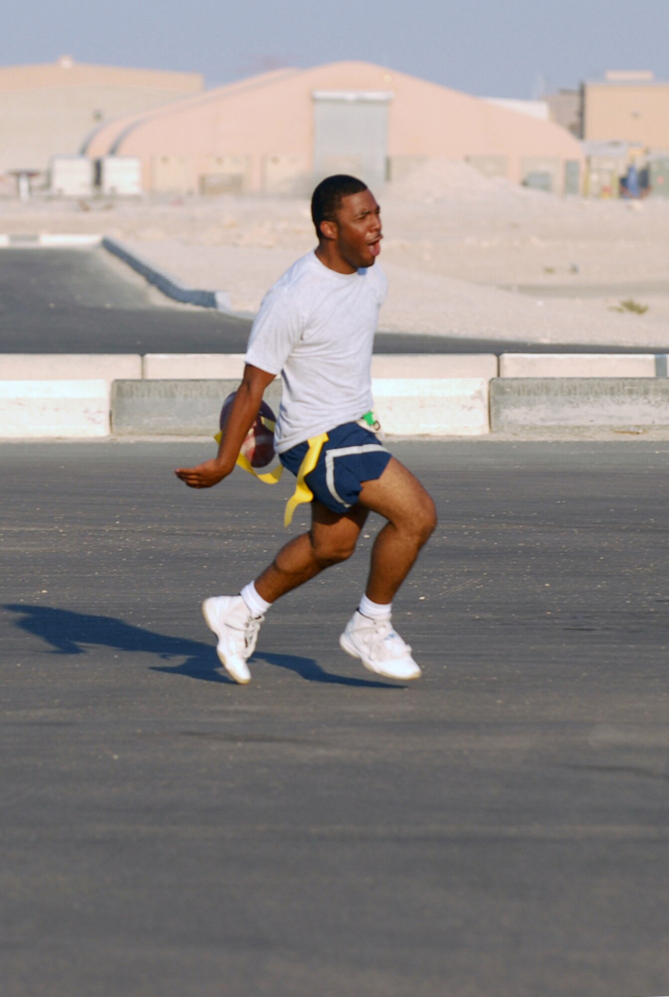 SOUTHWEST ASIA - Part of the Thanksgiving Day festivities at a Southwest Asia air base included a flag football game between the 379th Expeditionary Security Forces Squadron law enforcers and the 379th Expeditionary Civil Engineer Squadron  fire fighters. Airman 1st Class Artie Johnson scores a 379th ESFS touchdown. (U. S. Air Force photo/Staff Sgt. Douglas Olsen)

