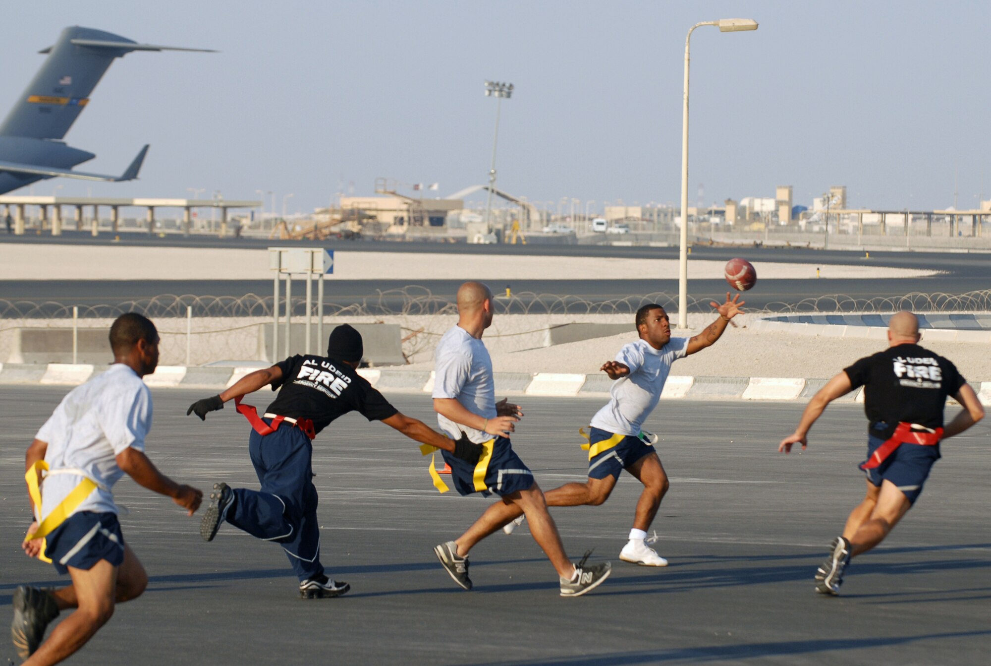 SOUTHWEST ASIA - Part of the Thanksgiving Day festivities at a Southwest Asia air base included a flag football game between the 379th Expeditionary Security Forces Squadron law enforcers and the 379th Expeditionary Civil Engineer Squadron  fire fighters. Airman 1st Class Artie Johnson reaches out to catch a pass for  379th ESFS. (U. S. Air Force photo/Staff Sgt. Douglas Olsen)


