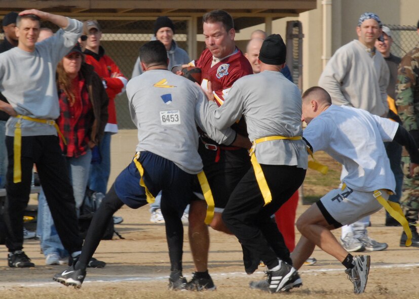 KUNSAN AIR BASE, South Korea—  Chief Master Sgt. Henry Gillen, 8th Operations Support Squadron, gets tackled after making the first down here Nov. 23. The chiefs won the game 20 to 6 against the commanders. The game is one of several sporting competitions between the two groups that have taken place during the course of the year.  (U.S. Air Force Photo/Staff Sgt. Araceli Alarcon)