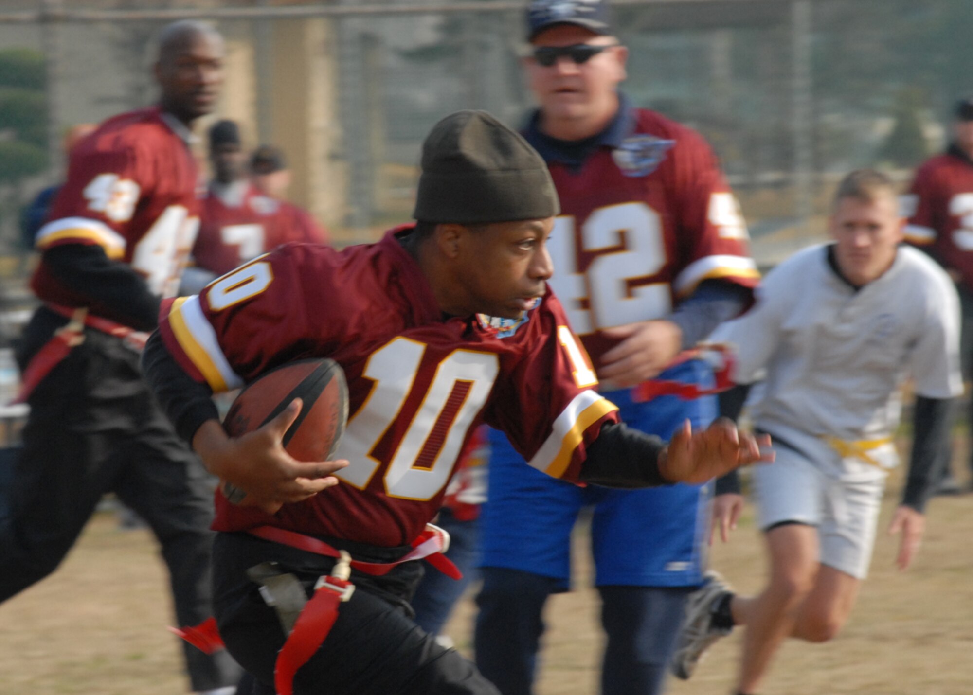 KUNSAN AIR BASE, South Korea—  Chief Master Sgt. Anthony Brinkley, 8th Fighter Wing command chief, runs 10 yards for a first down here Nov. 23. The chiefs won the game 20 to 6 against the commanders. The game is one of several sporting competitions between the two groups that have taken place during the course of the year.  (U.S. Air Force Photo/Staff Sgt. Araceli Alarcon)