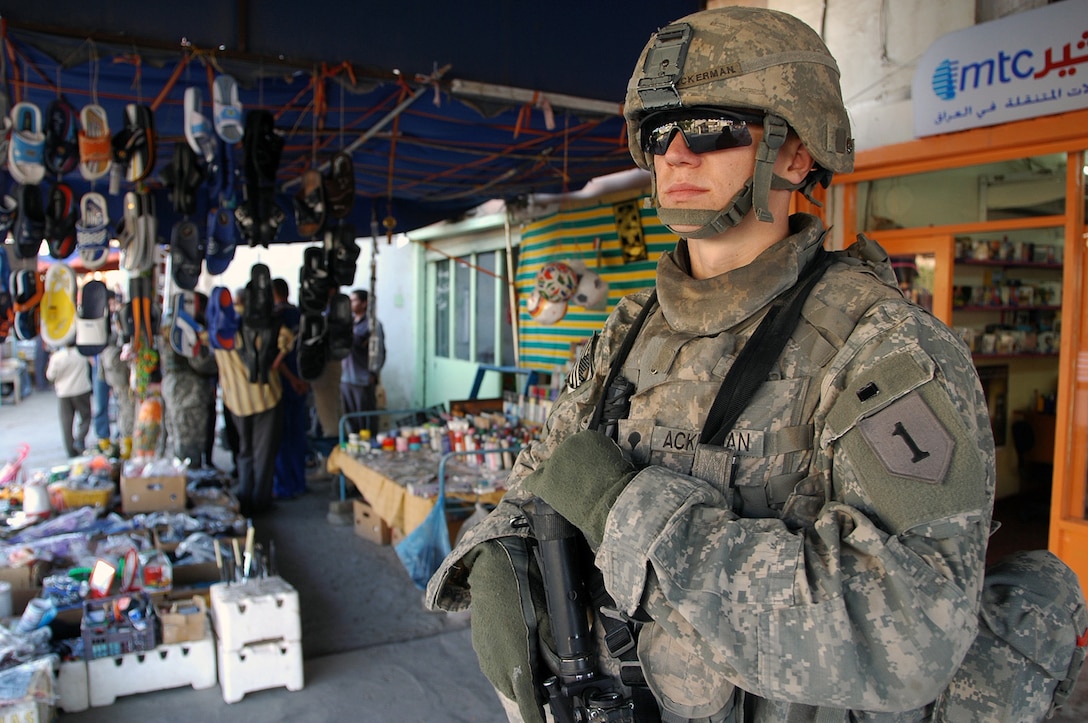 Army Spc. John Ackerman, a medic with the Civil Military Operations Platoon, Headquarters and Headquarters Battery, 2nd Battalion, 32nd Field Artillery Regiment, 4th Infantry Brigade Combat Team, 1st Infantry Division, keeps watch as members of his platoon conduct a census of the Daklea Market in the Yarmouk neighborhood of Baghdad, Nov. 18, 2007. Photo by Sgt. 1st Class Robert Timmons, USA