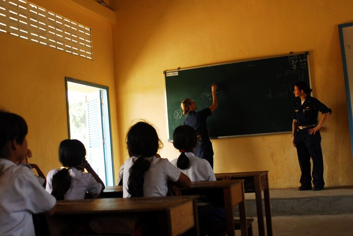 Sihanoukville, Kingdom of Cambodia (Nov. 27, 2007) - Electronics Technician 3rd Class Rosemary Colbert and Lt. jg. Constancia Schlemmer draw pictures on the black board of the Hun Sen Krong primary school, during a community relations project Nov 27. Essex and the embarked 31st Marine Expeditionary Unit (MEU) arrived in Sihanoukville, Kingdom of Cambodia, Nov 26, for a scheduled port visit that gives Sailors and Marines the opportunity to participate in friendship-building community relations events, medical and dental projects and professional exchanges.  These friendship-building events are being conducted with the cooperation of  the Cambodian military and the Kingdom of Cambodia.  The visit also provides Sailors and Marines the opportunity to meet local citizens and experience the customs and traditions of the Cambodian people.  Essex is the lead ship of the only forward-deployed U.S. Expeditionary Strike Group and serves as the flagship for CTF 76, the Navyâ??s only forward-deployed amphibious force commander.  Task Force 76 is headquartered at White Beach Naval Facility, Okinawa, Japan, with a detachment in Sasebo, Japan.  (U.S. Navy Photo by Mass Communication Specialist 2nd Class Drae Parker