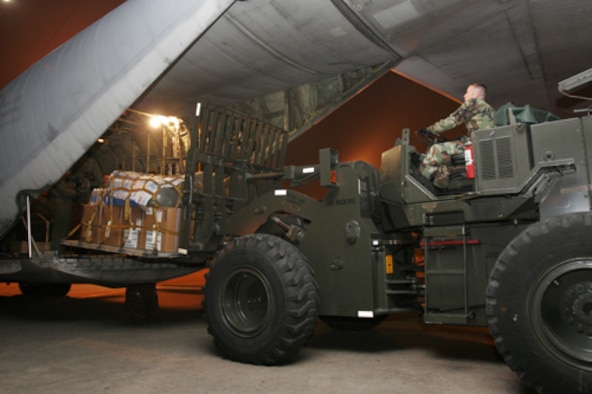 Staff Sgt. Robert C. Ward, a combat mobility team member with the 15th Logistics Readiness Squadron, Hickam Air Force Base, Hawaii, unloads an Interagency Emergency Health Kit from a U.S. Marine KC-130 Hercules aircraft in Dhaka, Bangladesh Nov. 24. The IEHK contains essential medicines and medical devices necessary to support the health needs of 10,000 people for three months. The KC-130 arrived loaded with the IEHK and other humanitarian supplies. The U.S. Air Force is assisting U.S. military efforts as part of a United States response in support of the Bangladeshi government’s request for assistance following the devastation caused by Cyclone Sidr. Sidr struck the southern coast of Bangladesh Nov. 15. The U.S. effort is being coordinated by the Department of State and U.S. Agency for International Development. (U.S. Marine Corps photo by Cpl. Eric D. Arndt)