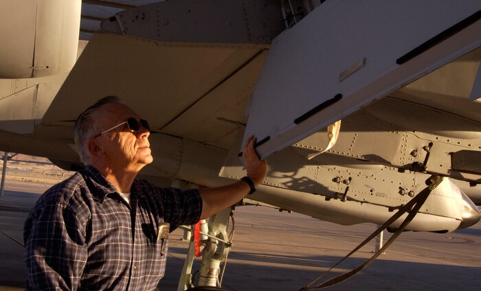 Bruce Ronzheimer, a civil service aircraft mechanic with the 57th Equipment Maintenance Squadron, demonstrates the standard checks performed on an A-10 aircraft. Mr. Ronzheimer retires Nov. 30th after nearly 50 years of combined military and civilian service in the Air Force. (Air Force photo by Airman 1st Class Oleksandra G. Manko)