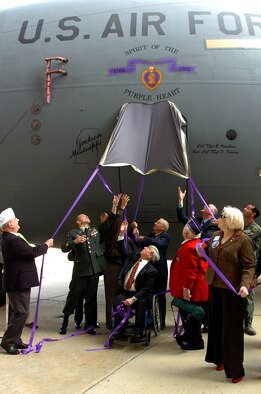 Purple Heart recipients and National Guardsmen unveil special nose art on a Mississippi Air National Guard C-17 Globemaster III during an aircraft naming and dedication ceremony Nov. 20 at the 172nd Airlift Wing in Jackson, Miss.  The wing routinely flies aeromedical evacuation missions from Iraq to Germany, and then on to the U.S. Aircrews have transported more than 19,000 patients since the wing's mobilization for the mission in October 2005. (U.S. Air Force photo/Tech. Sgt. Mike Smith)