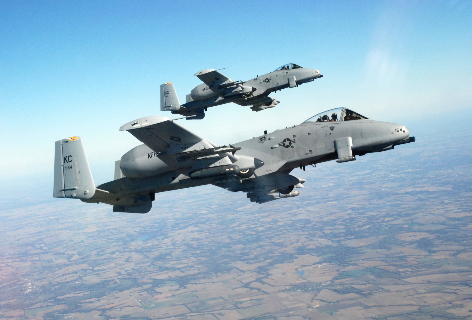 Two A-10 Thunderbolt IIs from the 442nd Fighter Wing, fly formation off the wing of a KC-135 Stratotanker during the  wing's Employer Appreciation Day, Nov. 3. Civilian employers of wing reservists were treated to a ride in two of the aerial tankers during the event. The 442nd FW is an Air Force Reserve unit at Whiteman AFB, Mo. (U.S. Air Force photo/Staff Sgt. Tom Talbert)