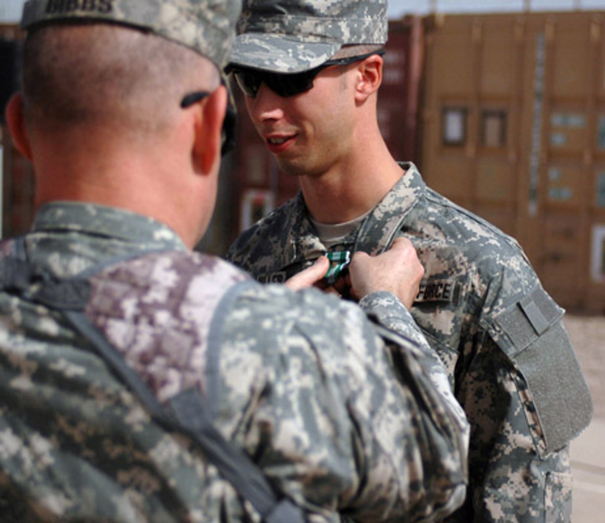 Colonel Ricky D. Gibbs, commander of the 4th Infantry Brigade Combat Team, 1st Infantry Division, pins the Army Commendation Medal with 'V' Device for valor onto Air Force Office of Special Investigations Special Agent Travis Guthmiller at Forward Operating Base Falcon in the Rashid District of Baghdad. Special Agent Guthmiller is part of Task Force Troy and attached to the 610th Brigade Support Battalion, was awarded the medal for rendering medical aid to a Soldier and saving his life. (U.S. Army photo by Sgt. 1st Class Robert Timmons) 