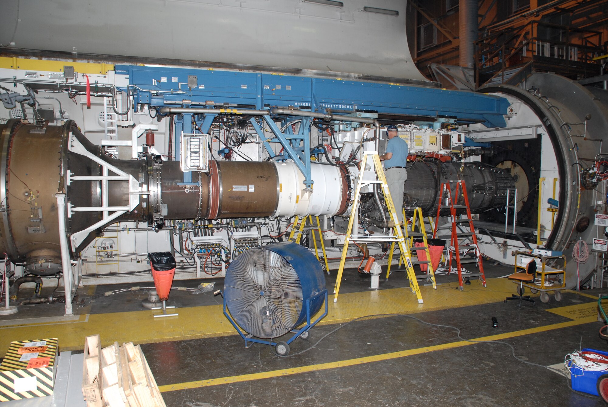 A test technician prepares the General Electric F101 engine for testing at Arnold Engineering Development Center, Arnold Air Force Base, Tenn. The F101 engine is slated to be the first high performance, supersonic engine to be certified to run on a 50-50 blend of Fisher-Tropsch synthetic fuel and JP-8 fuel. (AEDC photo)