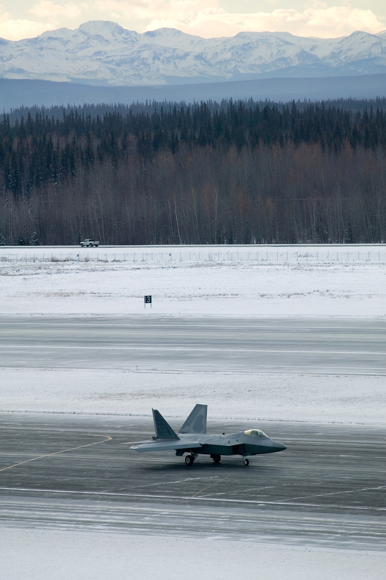 EIELSON AIR FORCE BASE, Alaska-- An F-22 Raptor crew from Edwards AFB, Calif., performs 60-knot testing on low runway conditions Nov. 8 on the south ramp of the flightline. The Raptor underwent cold-weather testing on its breaking system, with imphasis on its ability to maneuver, stop and go on slippery surfaces. The aircraft was tested by the 411th Flight Test Squadron during a three-week deployment on incrementally low-level runway condition reading surfaces, with temperatures ranging between 37 to -13 degrees, with an objective to have the report finished by Elmendorf's first winter. (U.S. Air Force photo by Kevin Roberston)