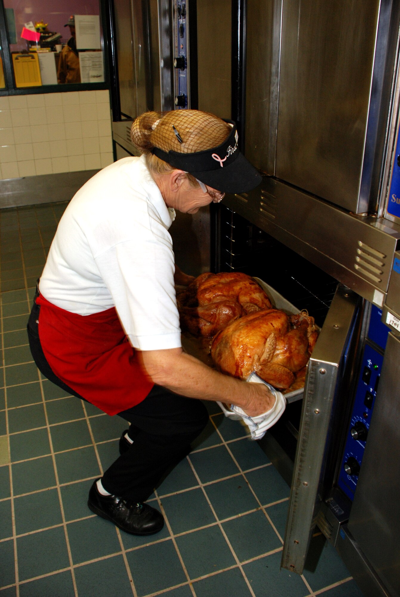 Connie Ermis, first cook at the Tumbleweed Dining Facility, checks on a turkey Nov. 21. (U.S. Air Force photo/Airman 1st Class Jacob Corbin)