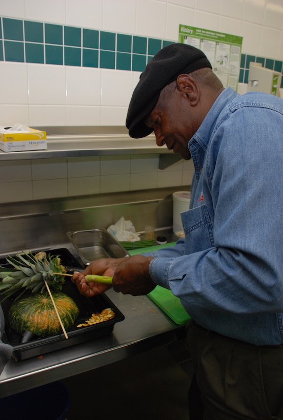 Al Graham, a project manager with Work Services, assembles a fruit and vegetable turkey prior to Thanksgiving Nov. 21 at the Tumbleweed Dining Facility. (U.S. Air Force photo/Airman 1st Class Jacob Corbin)