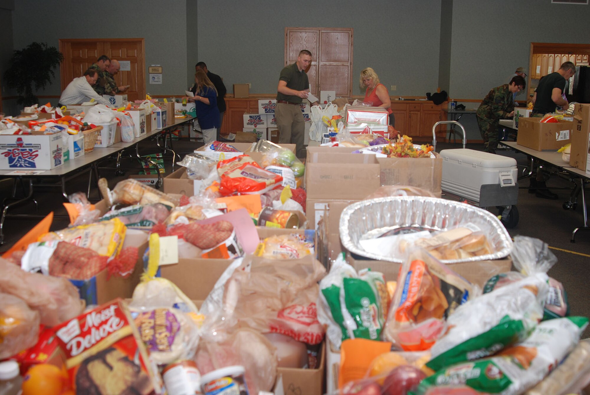 MCCONNELL AIR FORCE BASE, Kan. -- Boxes amongst boxes of holiday dinner items line the tables of the Chapel Annex, Nov. 20, at a Thanksgiving food basket fundraiser held by the Airman and Family Readiness Center. Team McConnell families were able to pick up a free holiday food basket for Thanksgiving dinner curtsey of base-wide donations. (Photo by Airman 1st Class Jessica Lockoski)