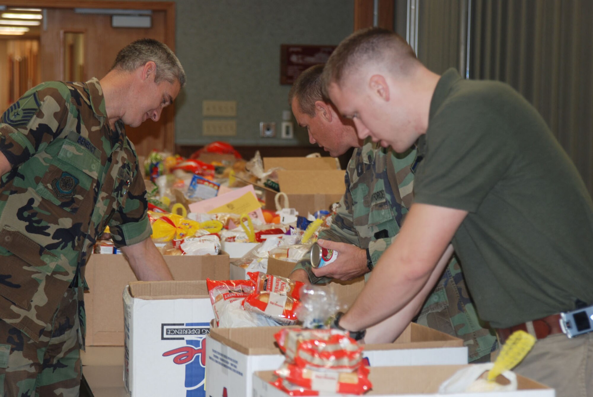 MCCONNELL AIR FORCE BASE, Kan. -- Volunteers sort food items at a holiday food basket fundraiser held by the Airman and Family Readiness Center, Nov. 20, at the base Chapel Annex. Team McConnell families were able to pick up a free holiday food basket for Thanksgiving dinner curtsey of base-wide donations. (Photo by Airman 1st Class Jessica Lockoski)