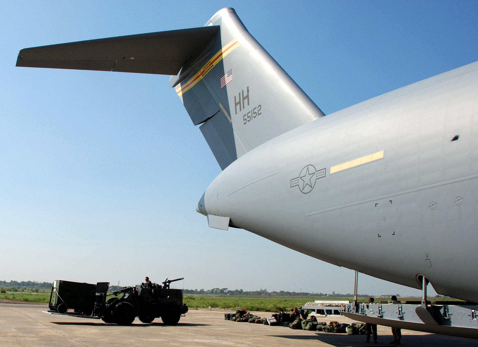 Airmen offload cargo from a C-17 Globemaster III Nov. 26 at Zia International Airport in Dhaka, Bangladesh. A 37-person team from the 36th Contingency Response Group from Andersen Air Force Base, Guam, will establish relief supply transload operations in the wake of a Nov. 15 tropical cyclone that devastated much of the southern part of the country. The C-17 and crew are from the 535th Airlift Squadron at Hickam AFB, Hawaii. (U.S. Air Force photo/1st Lt. Michael Boyer)