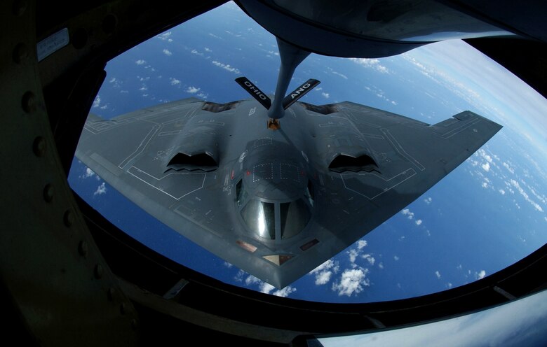 A KC-135 Stratotanker refuels a B-2 Spirit Nov. 20 over the Pacific Ocean. The B-2 and KC-135 are deployed to Andersen Air Force Base, Guam, to support U.S. Pacific Command's continuous bomber presence and theater security package operations. The KC-135 is assigned to the from the 121st Refueling Squadron from Rickenbacker International Airport at Columbus, Ohio. The B-2 is assigned to the 509th Bomb Wing from Whiteman AFB, Mo. (U.S. Air Force photo/Senior Airman Brian Kimball) 
