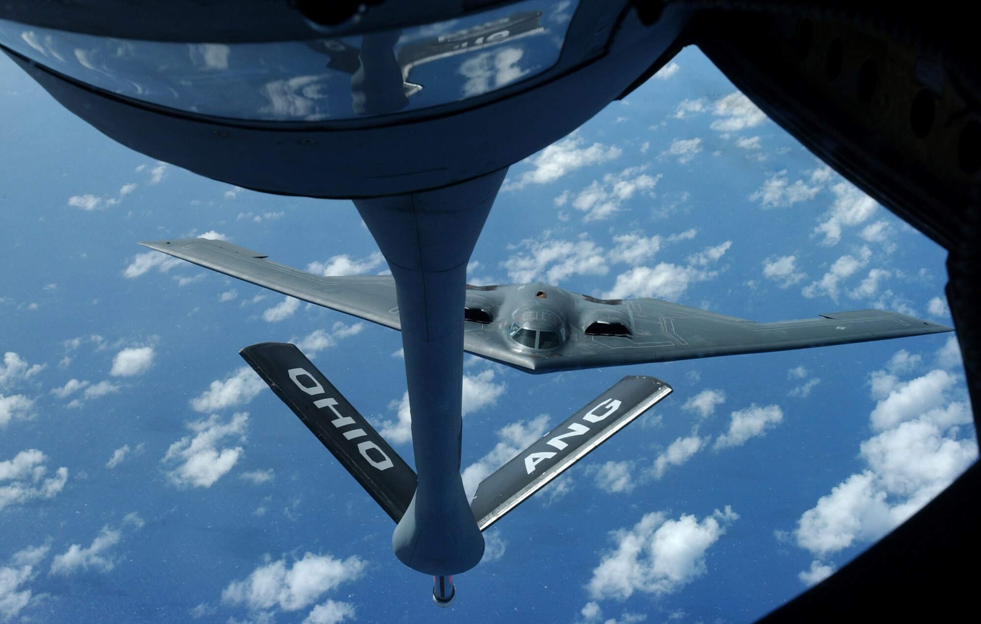 A KC-135 Stratotanker prepares for a mid-flight refueling with a B-2 Spirit Nov. 20 over the Pacific Ocean. The B-2 and KC-135 are deployed to Andersen Air Force Base, Guam, to support U.S. Pacific Command's continuous bomber presence and theater security package operations. The KC-135 is assigned to the from the 121st Refueling Squadron from Rickenbacker International Airport at Columbus, Ohio. The B-2 is assigned to the 509th Bomb Wing from Whiteman AFB, Mo. (U.S. Air Force photo/Senior Airman Brian Kimball)
