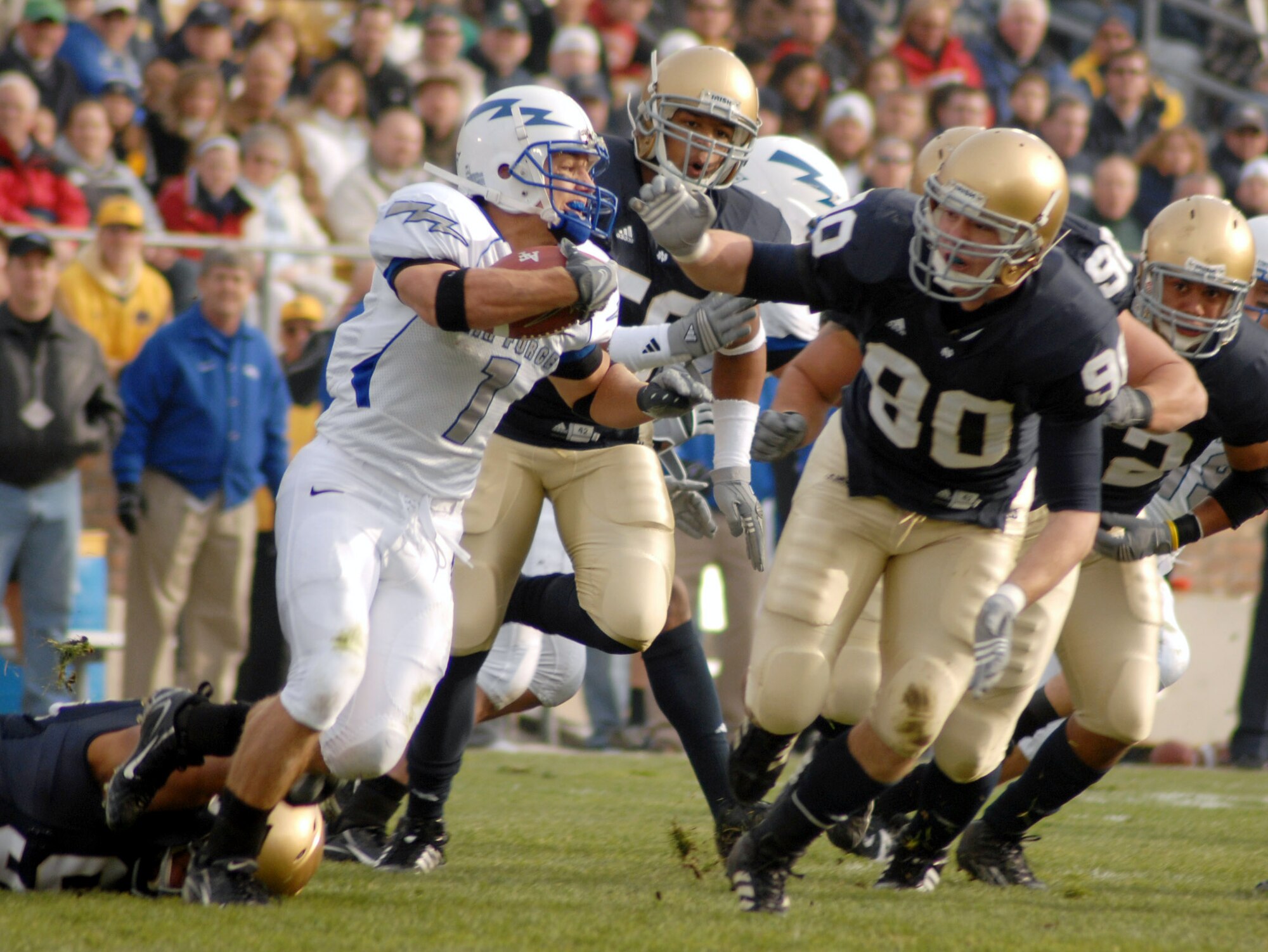 U.S. Air Force Academy z-back Chad Hall tries to evade Notre Dame's John Ryan in the Falcons' 41-24 victory over the Irish Nov. 10 in South Bend, Ind. U.S. Air Force Academy officials have accepted a bid to play in the Bell Helicopter Armed Forces Bowl on New Year's Eve at Fort Worth, Texas. (Photo courtesy of Vanessa Gempis)