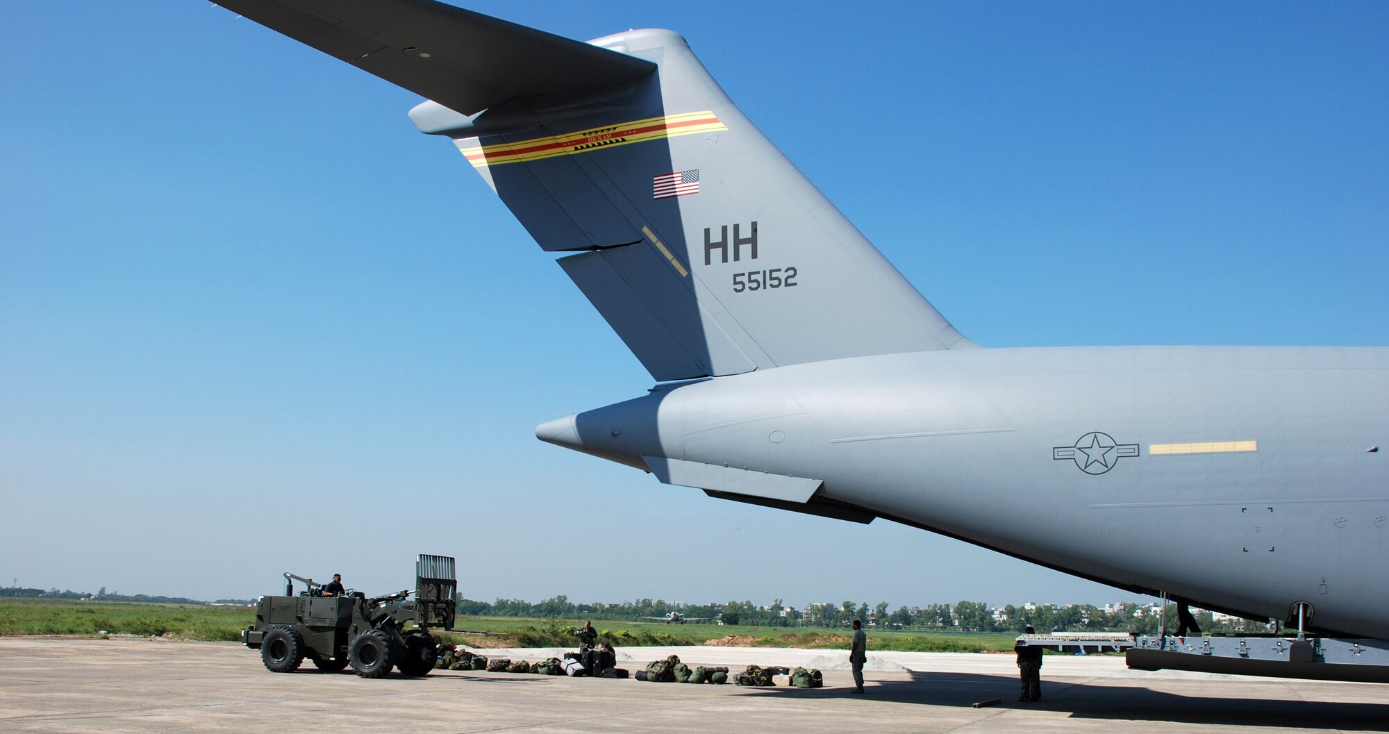Airmen offload cargo from a C-17 Globemaster III Nov. 26 at Zia International Airport in Dhaka, Bangladesh. A 37-person team from the 36th Contingency Response Group from Andersen Air Force Base, Guam, will establish relief supply transload operations in the wake of a Nov. 15 tropical cyclone that devastated much of the southern part of the country. The C-17 and crew are from the 535th Airlift Squadron at Hickam AFB, Hawaii. (U.S. Air Force photo/1st Lt. Michael Boyer) 
