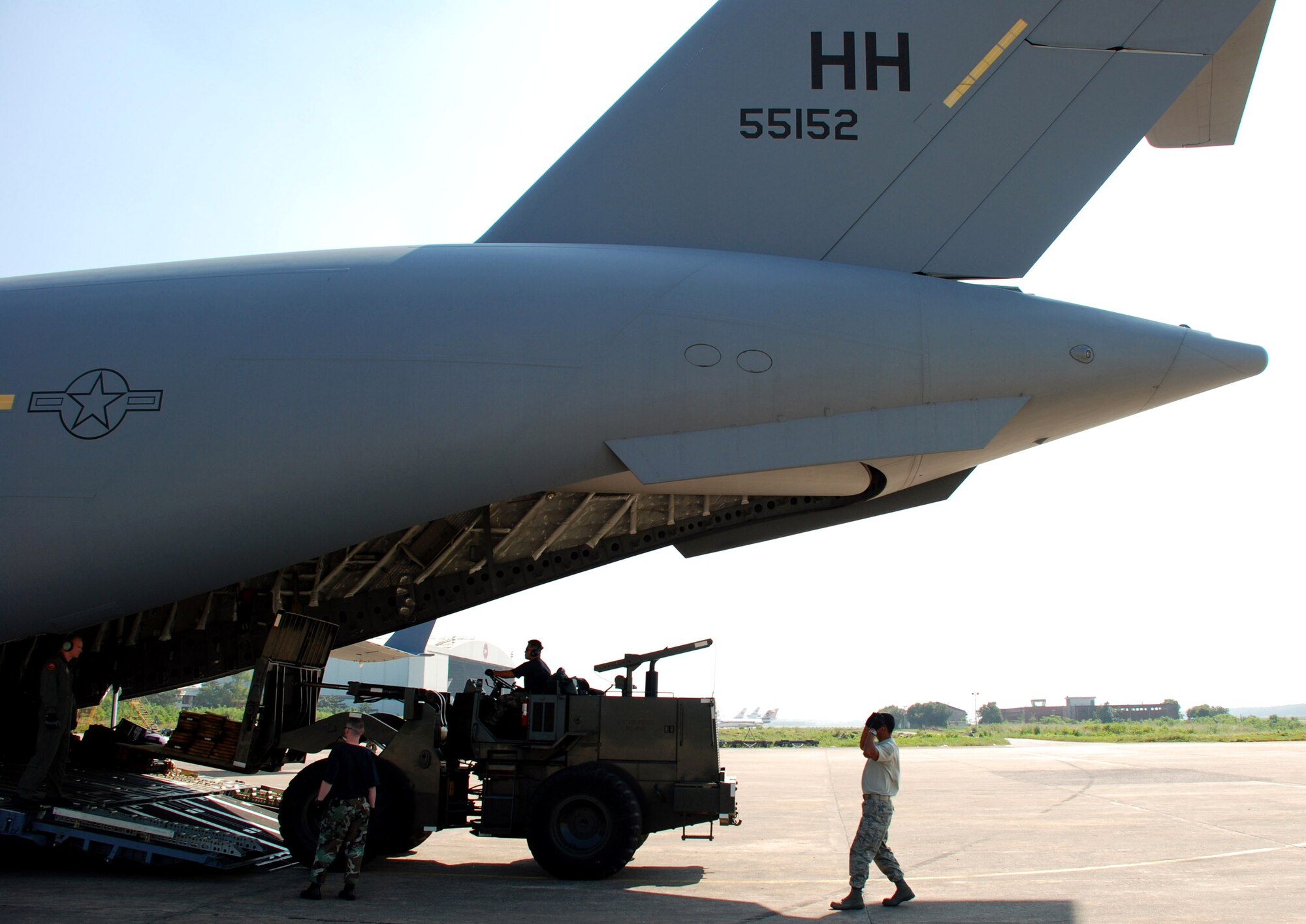 Airmen offload cargo from a C-17 Globemaster III Nov. 26 at Zia International Airport in Dhaka, Bangladesh. A 37-person team from the 36th Contingency Response Group from Andersen Air Force Base, Guam, will establish relief supply transload operations in the wake of a Nov. 15 tropical cyclone that devastated much of the southern part of the country. The C-17 and crew are from the 535th Airlift Squadron at Hickam AFB, Hawaii. (U.S. Air Force photo/1st Lt. Michael Boyer) 
