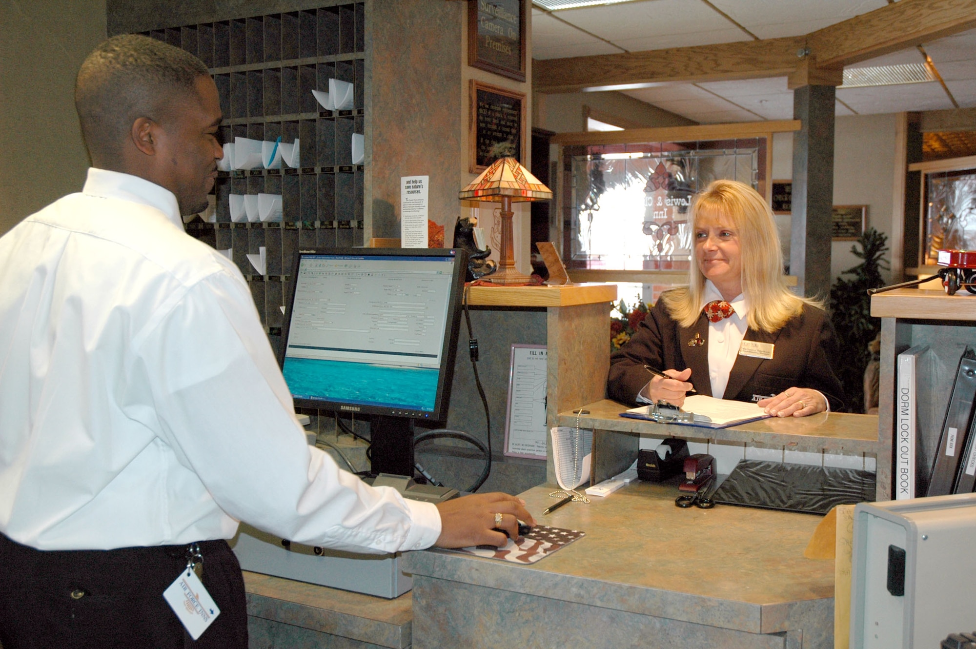 Veronica Davison, 341st Services Squadron housekeeping manager, discusses room availability with Antonio Hicks, civilian lodging clerk, at the Malmstrom Inns and Suites Nov. 20. Ms. Davison was awarded the 2007 Innkeeper of the Year award for the Air Force Nov. 10 in New York City. (U. S. Air Force photo/Senior Airman Eydie Sakura)