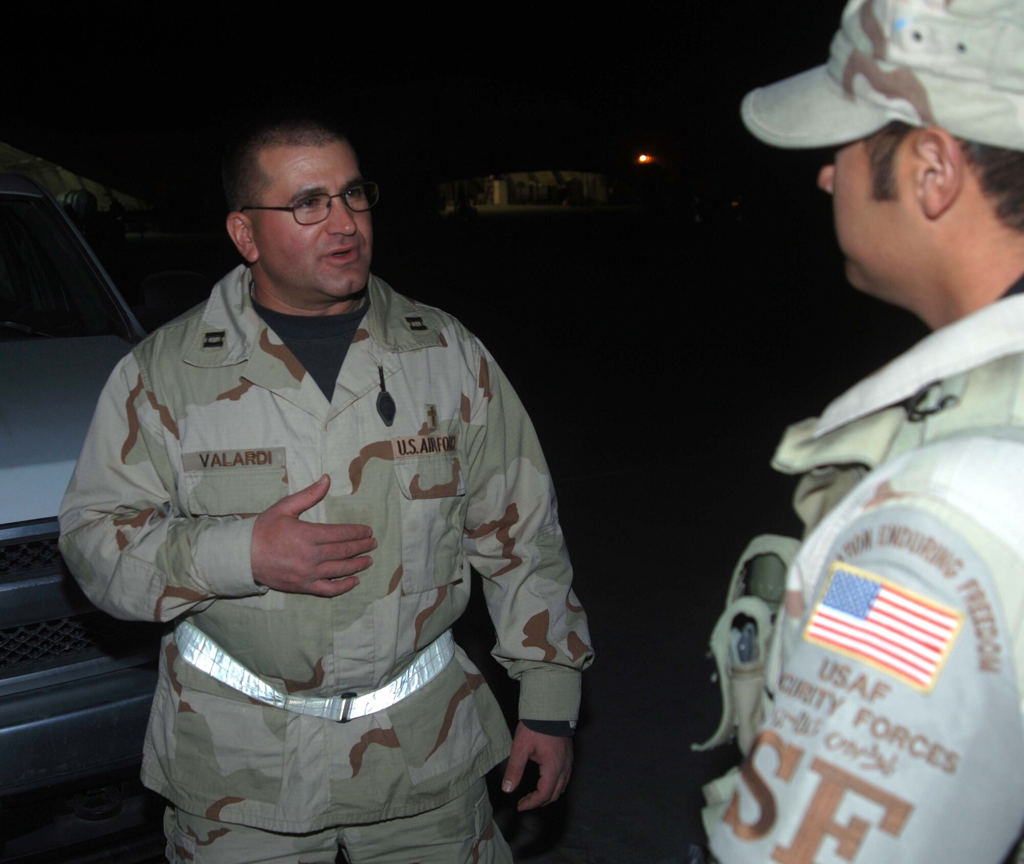 BAGRAM AIR BASE, Afghanistan -- Capt. Ken Valardi, 455th Air Expeditionary Wing Command Chaplain, visits with Airman 1st Class Carlos Rosario, 455th Expeditionary Security Forces Squadron, Nov. 26, 2007.  Chaplain Valardi leads a group that regularly brings hot beverages and fellowship to wing Airmen working the night shift. 
(U.S. Air Force Photo by Capt. Michael Meridith)

