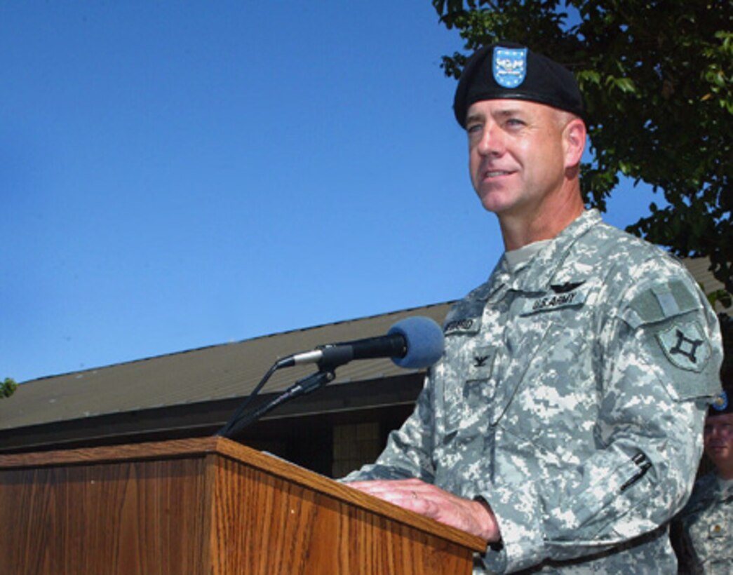 Col. Richard Bedard speaks to the assembled members of the Army National Guard 50th Area Support Group, a Homestead Air Reserve Base tenant unit, immediately after assuming command of the unit Nov. 18. "Leadership is a contact sport," he said. The colonel promised soldiers he will be visible and involved during his tour as commander. (Photo by Jon Myatt, Dept. of Military Affairs)