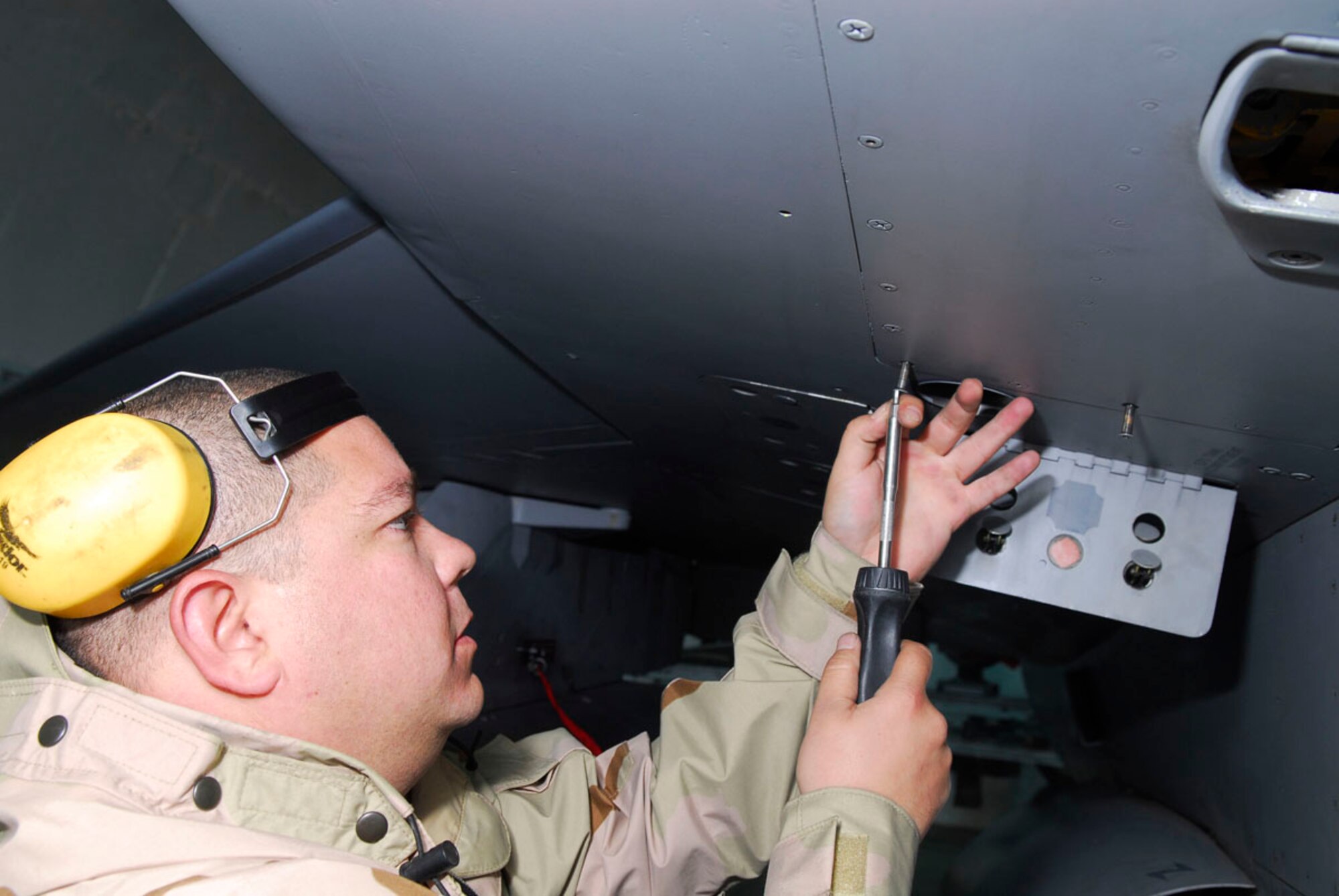 BALAD AIR BASE, Iraq -- Staff Sgt. Jeremiah Lagestam, a 332nd Expeditionary Aircraft Maintenance Squadron Aircraft Maintenance Unit weapons loader, secures the tailfins of a Guided Bomb Unit 13 here, Nov. 27. The GBU-13 is one of the three main munitions used by the fighter squadrons here. Sergeant Lagestam is deployed from Hill Air Force Base, Utah. (U.S. Air Force photo illustration/Staff Sgt. Joshua Garcia)