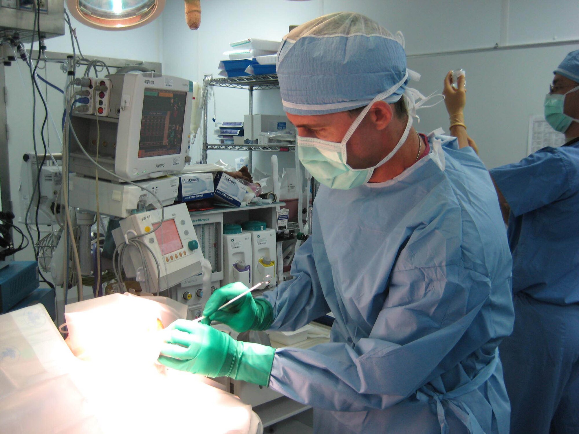 BAGRAM AIR BASE, Afghanistan - Air Force neurosurgeon Lt. Col. (Dr.) Randall McCafferty performs surgery on a young Afghan girl suffering from an arachnoid cyst or “water on the brain” at the Craig Joint Theater Hospital here. Without the help of McCafferty’s expertise the young girl, who is now in good condition, was not expected to survive.  (Courtesy photo)
