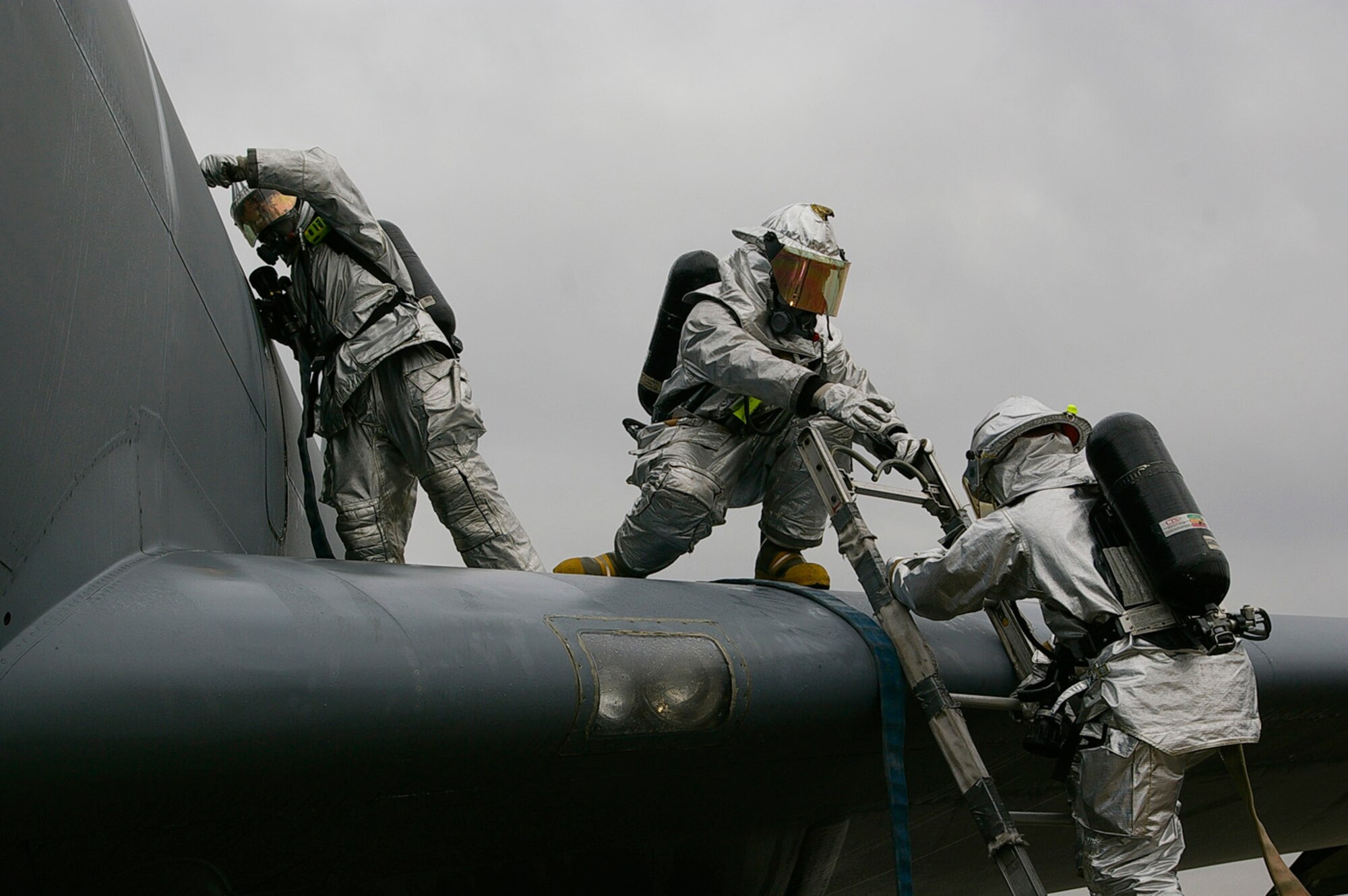 Both Ministry of Defence and U.S. Air Force firefighters from the 100th Civil Engineer Squadron Fire Department participated in the exercise. The scenario was a simulated fire on an aircraft engine, with two crew members unaccounted for. Fire crew had to enter the plane via a door above the wing, and search the aircraft for "personnel". Hands-on training and familiarization techniques are practiced quarterly by the fire department. Hands-on training keeps personnel familiar with the interior layout of the aircraft's proper shutdown procedures, and helps the firefighters think about the different types of problems they could encounter with this type of emergency. (Air Force photo by Karen Abeyasekere)