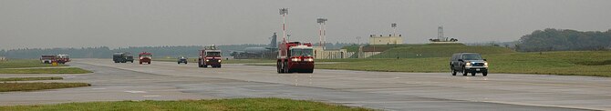 Vehicles from the 100th Civil Engineer Squadron Fire department convoy over to a hardstand on the south side of base Nov. 13 when they responded for a training exercise on a KC-135 Stratotanker. (U.S. Air Force photo by Karen Abeyasekere)