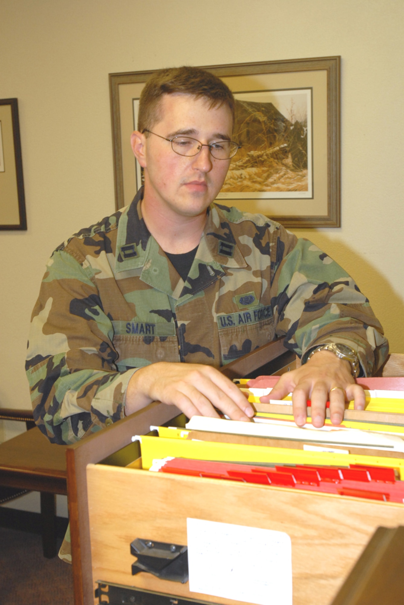 Capt. Maxwell Smart looks through office files to prepare for an upcoming case Nov. 27. (U.S. Air Force/Airman 1st Class Kasey Zickmund)